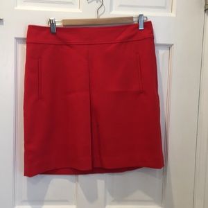 Loft red a-line skirt with kick-pleat detail.